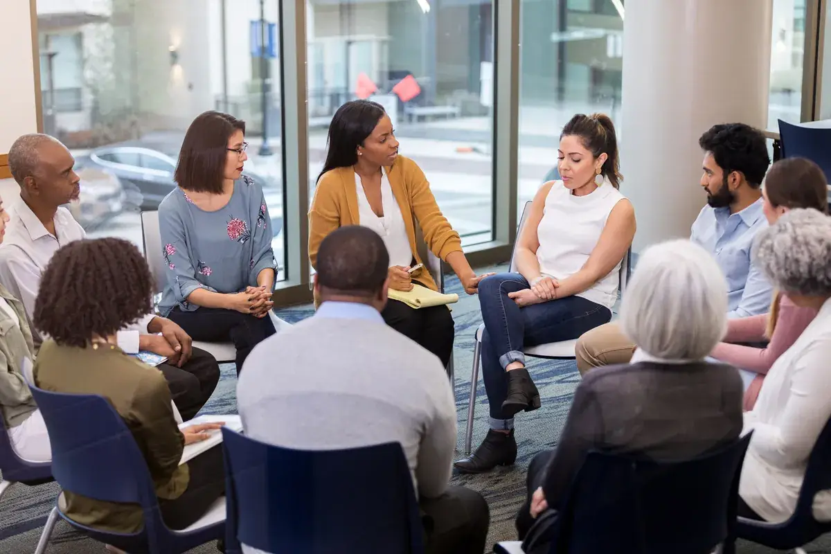 Participants sharing in a circle during a discipleship training session